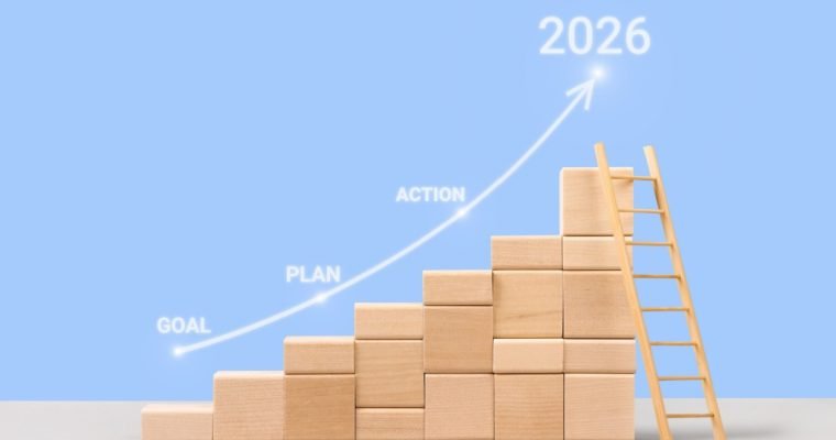 Wooden blocks stacked as stairs with a ladder and upward arrow pointing to 2026, illustrating iGaming market growth through goal, plan, and action