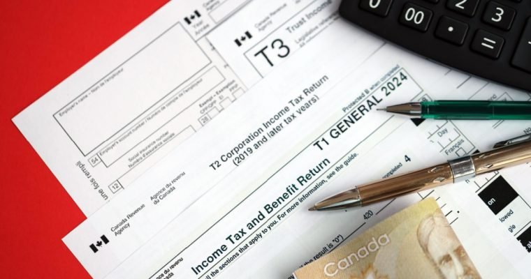 Canadian corporation tax return forms alongside Canadian currency and a calculator